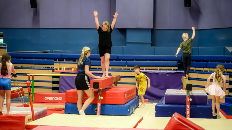 Girl on gymnastics beam