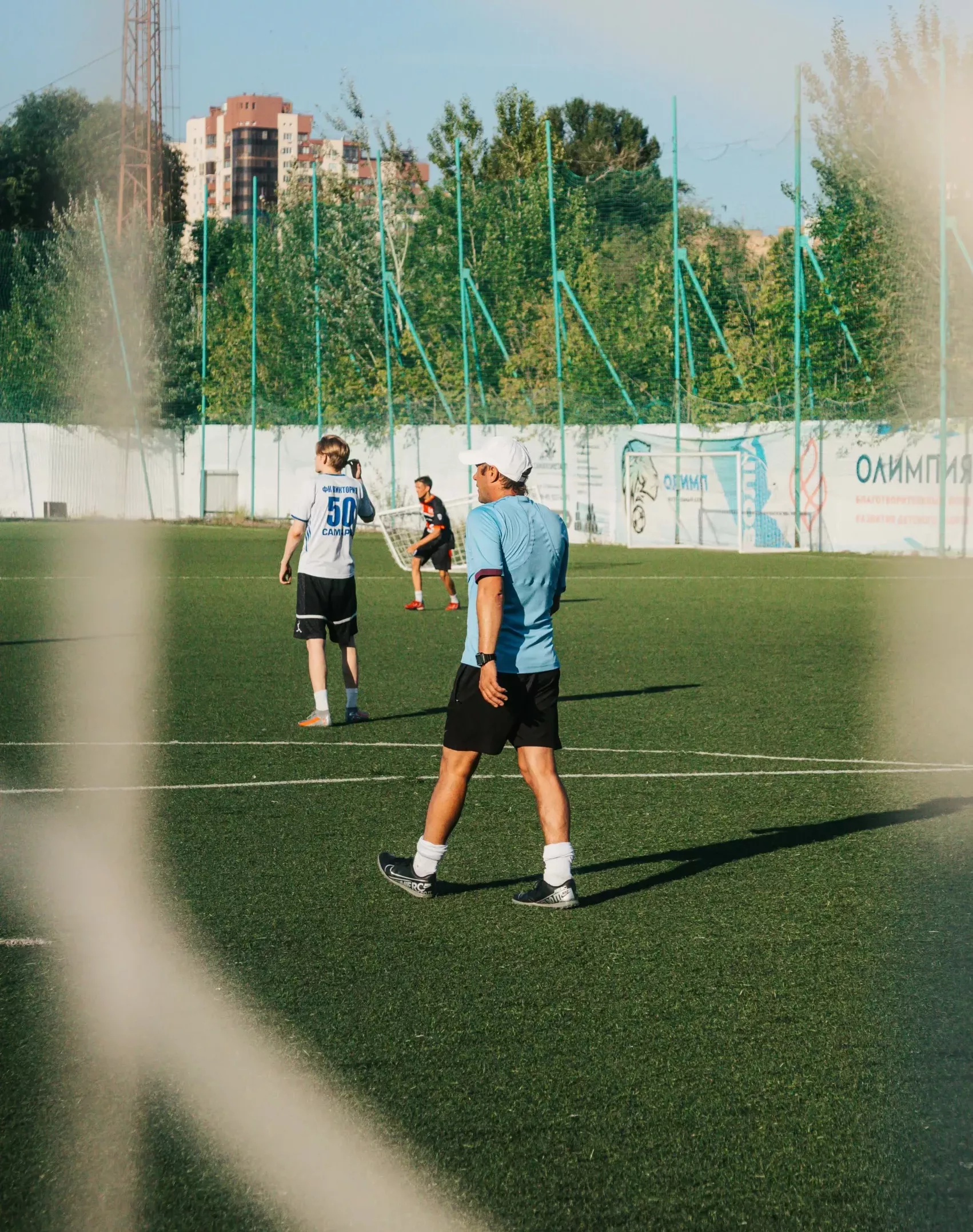 Man walking on a football field at Bolton Arena for walking sports