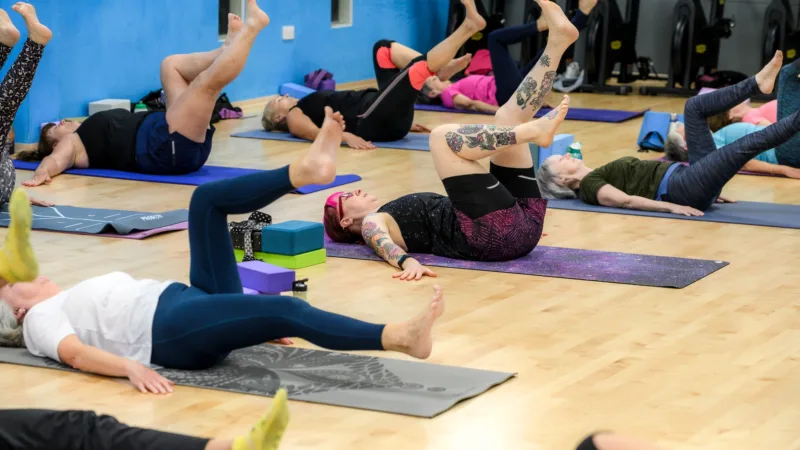 Yoga class performing core exercise at Active Bolton Arena