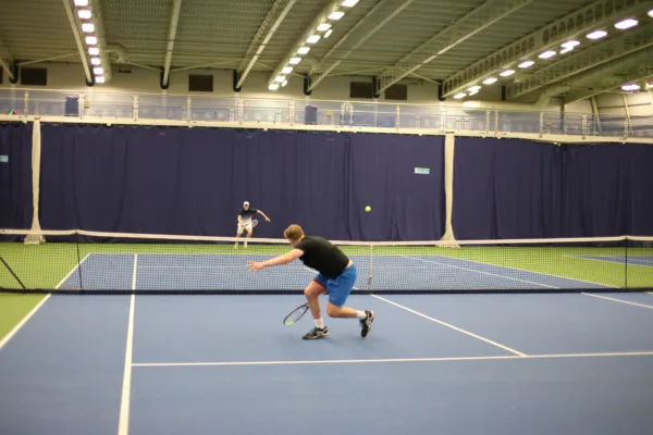 Two male adults playing tennis at Active Bolton Arena