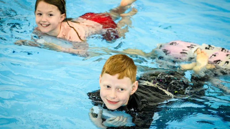 Boy and girl in the pool during a rookie lifeguard session