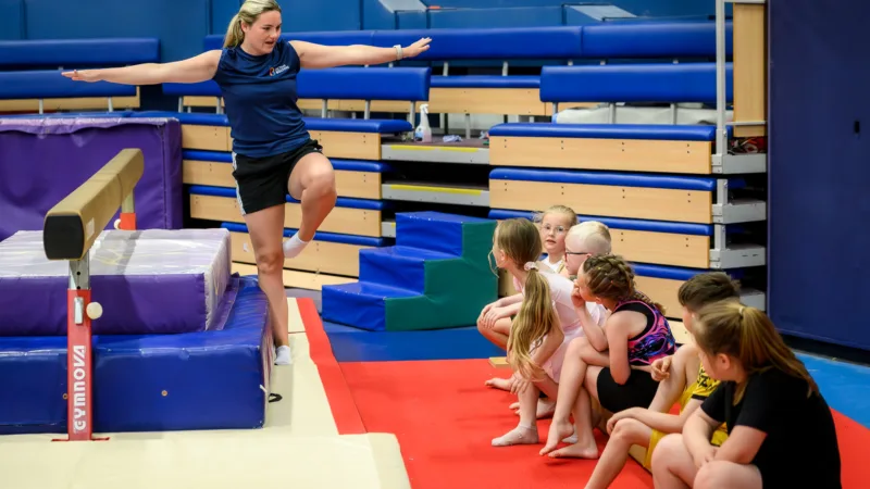 Gymnastics teacher providing demonstration at Gymnastics camp at Active Bolton Arena.