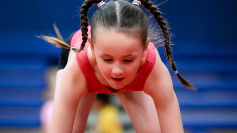 Girl using gymnastics equipment