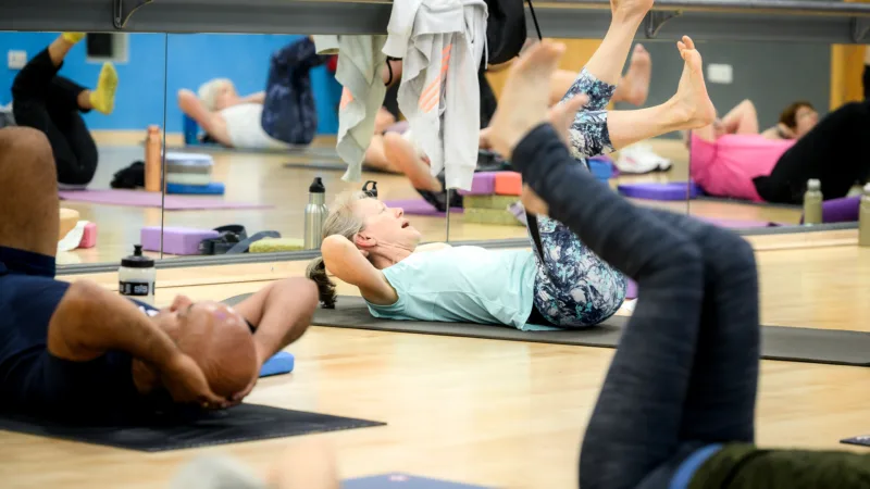 People participating in group fitness class