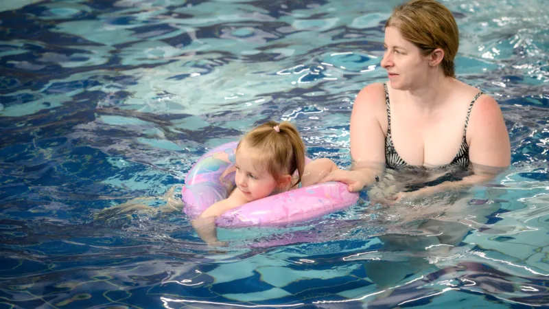 Adult and child in Farnworth Leisure Centre pool during adult and child swimming lessons
