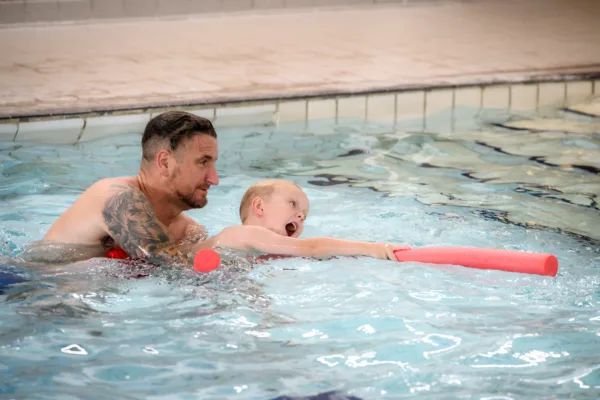 Adult and Child in pool during adult and child swimming lessons at Farnworth Leisure Centre