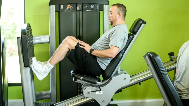Man using leg press machine