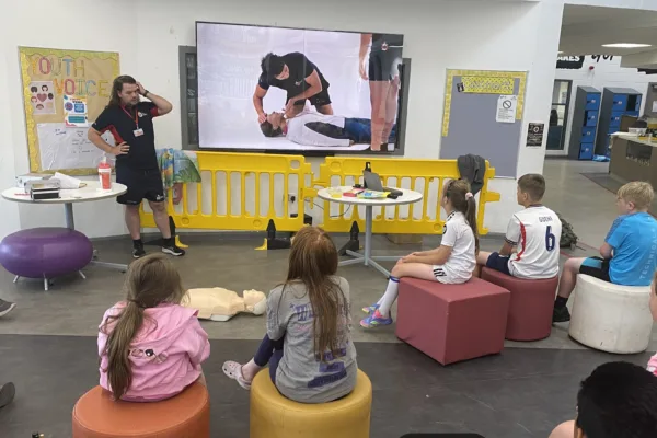 Children watching a water safety education presentation