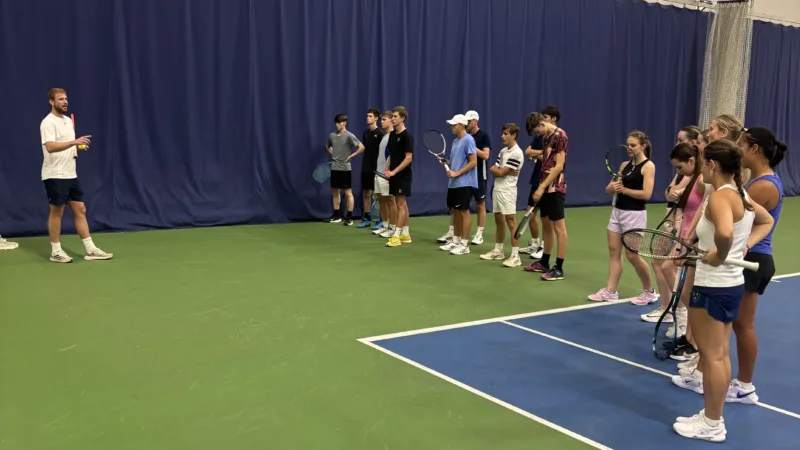 Children stood on tennis court at Active Bolton Arena during junior squad session.